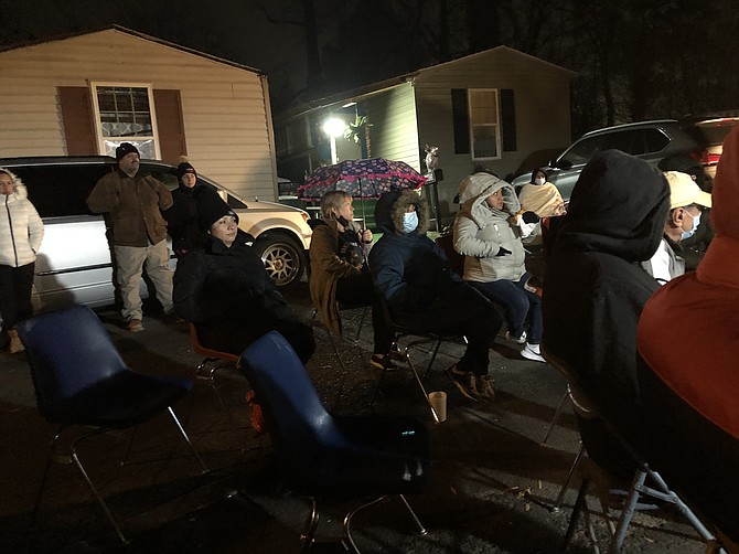 Harmony Place Trailer Park residents (left) listen to Chris Ebert, (foreground right) representative of Six Rock Properties, which purchased the property, discuss plans for making repairs and managing the park.