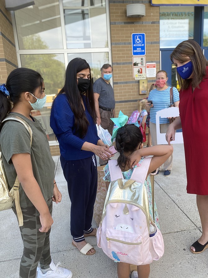 Masked students enter the FCPS’ Great Falls Elementary School.