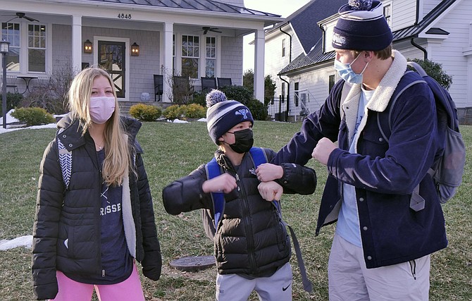 The Kaetzels: Connor (17), Sydney (15), and Logan (12), masked and ready for school. Connor and Sydney attend Yorktown High School, and Logan attends Williamsburg Middle School in Arlington. All nod affirmatively to the question of whether they expect some kids to arrive at school on Monday without masks.
