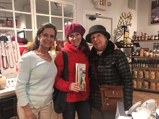 The Old Town Shop owner Valerie Ianieri, left, poses for a photo with Romanian tourists Lulia and Anca Teodoru in March of 2019. Ianieri announced that the popular gift shop will be relocating across the street to the former home of Old Town Books.