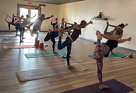 Yoga students doing a “Dancers Pose” during a class in the new studio. Photo courtesy of Alyson Pollard