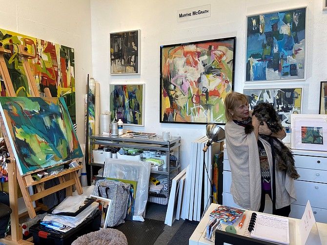 Marthe McGrath, resident artist at Reston Art Gallery & Studios and pup Milo in her workspace. Photo courtesy of Carol Nahorniak