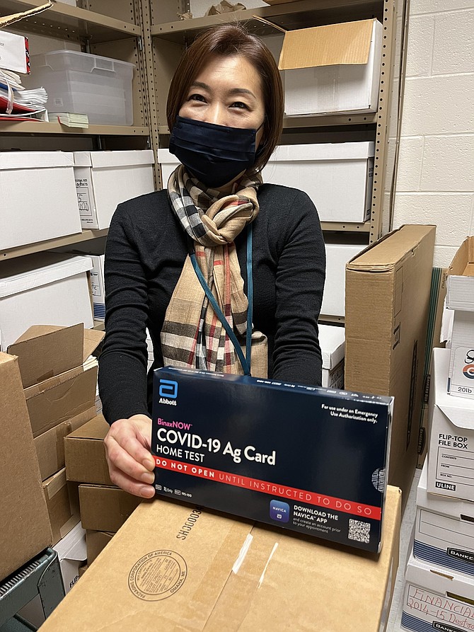 Jennie Choi, FCPS, removes one of BinaxNOW COVID-19 home tests that eligible COVID-exposed unvaccinated students can use to test at home and, if negative, can return to school without having to quarantine.