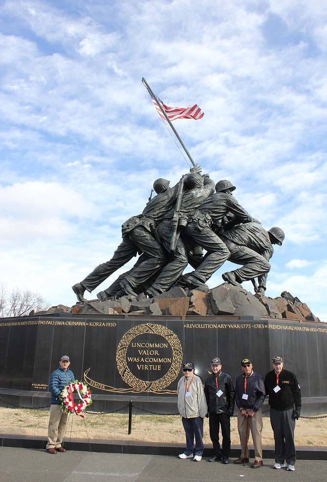 Survivors of the Battle of Iwo Jima gather for a photo following a wreath laying at the Marine Corps War Memorial Feb. 18 in Arlington. Pictured left to right are: Roy Earle, John DeGennarro, Louis Bourgault and Ivan Hammond.