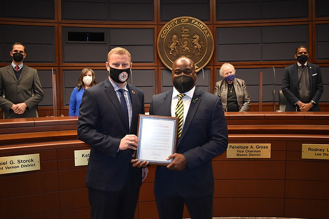 On Feb. 22, 2022, Dr. Gregory Washington, right, George Mason University's president, accepts the proclamation from Chairman Jeffrey C. McKay on behalf of the Fairfax County Board of Supervisors, recognizing the university's 50th anniversary.