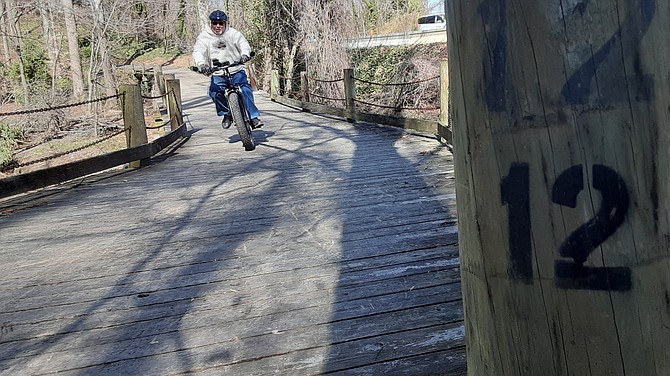 John Graumann knows to pick up speed on the bridge to make it up the hill on the other side.