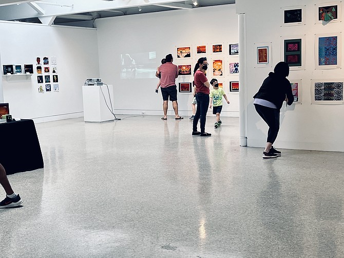 Visitors admire the works by featuring FCPS student artists elementary school to high school, at the McLean Pyramid Art held in the Emerson Gallery of McLean Project for the Arts at the McLean Community Center. The show encourages and inspires young artists.