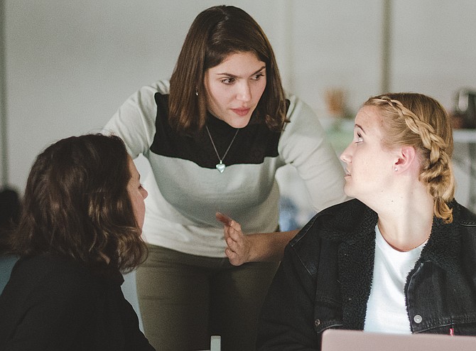 Emily Dillard (center) confers with two other producers about “Our Side.”