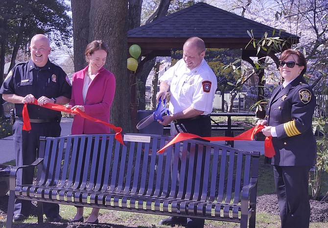 From Left: Police Chief Charles “Andy” Penn joined Department of Public Safety Communications and Emergency Management Public Affairs Manager Hannah Winant, Assistant Arlington County Fire Department Chief Joe Reshetar and Sheriff Beth Arthur in cutting the ribbon for the new bench dedication.