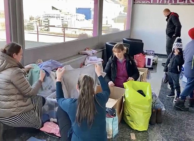 One group of seven Ukrainian women returns to the aid station day after day — not to shop, but to help organize, sort and assist as a way of giving back for the help they are receiving.