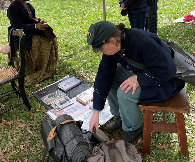 Reenactor Tracey McIntire dresses as a Union soldier and organizes her battle gear March 26 at Fort Ward Museum.