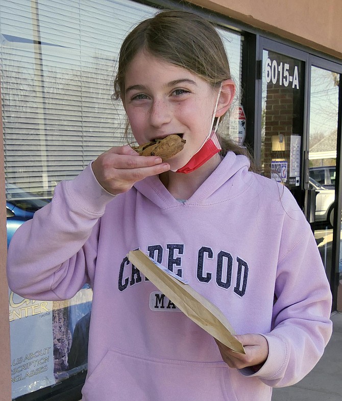 Eleven-year-old Lauren Bleicher has walked a few blocks from her house to taste the new cookies. She declares the cookie “super yummy and very chocolate-y.” Her mother, Margaret, comments it is nice to have an option close by because Crumbl is in Vienna and Levain is in Georgetown.
