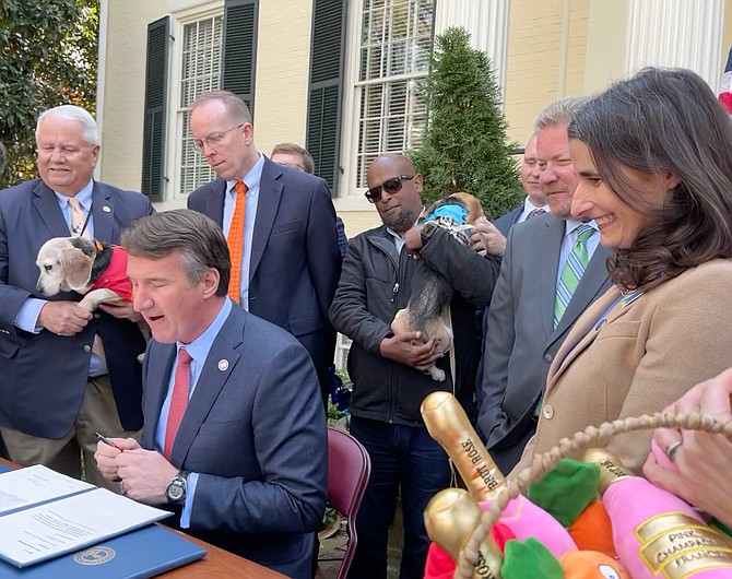 Governor Glenn Youngkin (seated) signs animal protection bills into law, with Del. Buddy Fowler (R-55th), Del. Rob Bell (R-58th), Sen. Bill Stanley (R-20th), and Sen. Jennifer Boysko (D-33rd)