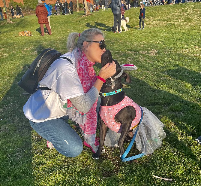 School Board member Tammy Ignacio kisses Luna Blue at the ALX Dog Walk April 2 in Oronoco Bay Park.