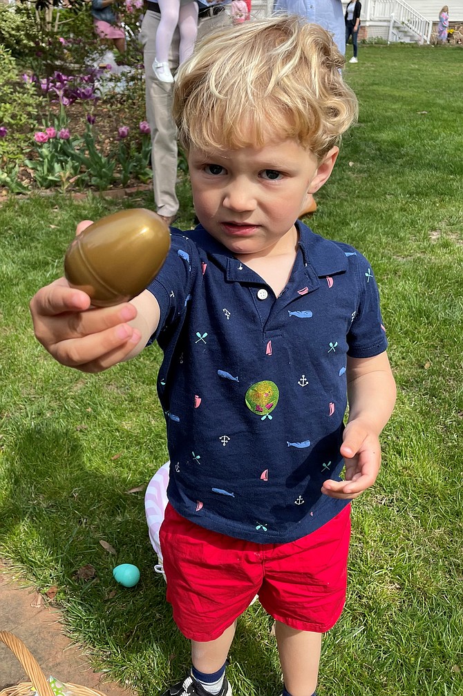 Lou DiMenna shows off the winning golden egg he found during the April 16 Easter Egg Hunt at Lee-Fendall House.