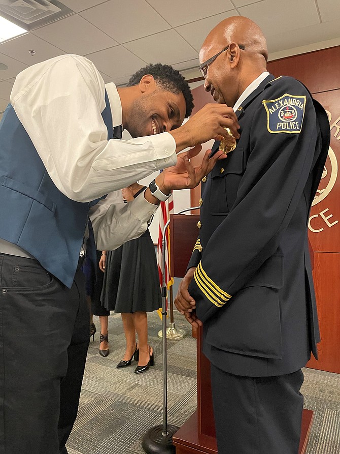Chief of Police Don Hayes, right, has his new badge pinned on by his son Quentin Hayes following the swearing-in ceremony April 18 at APD Headquarters.