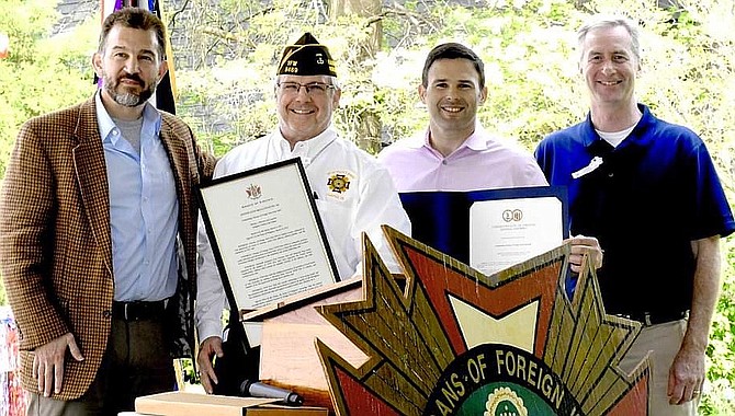 From left, Chap Petersen, Mac McCarl, Dan Helmer and David Bulova with the resolutions from the Virginia General Assembly.