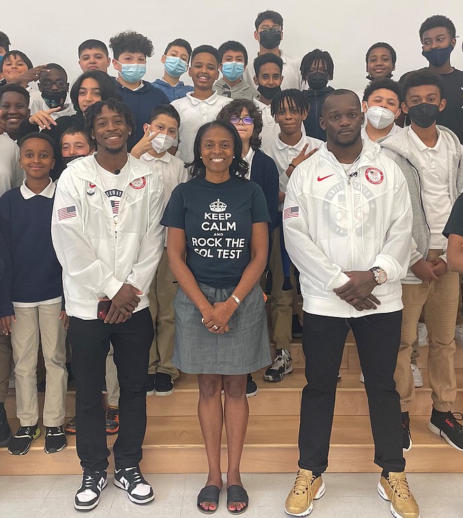 Patrick Henry Elementary School principal Ingrid Bynum, center, is flanked by Olympic boxers Keyshawn Davis and Troy Isley and school students during a special appearance May 4 by the elite athletes.
