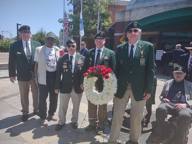 Members of Special Forces Association Chapter XI, who assisted in the May 30 Memorial Day Ceremony at the Captain Rocky Versace Plaza and Vietnam Veterans Memorial, gather for a group photograph at the statue of Rocky Versace.
