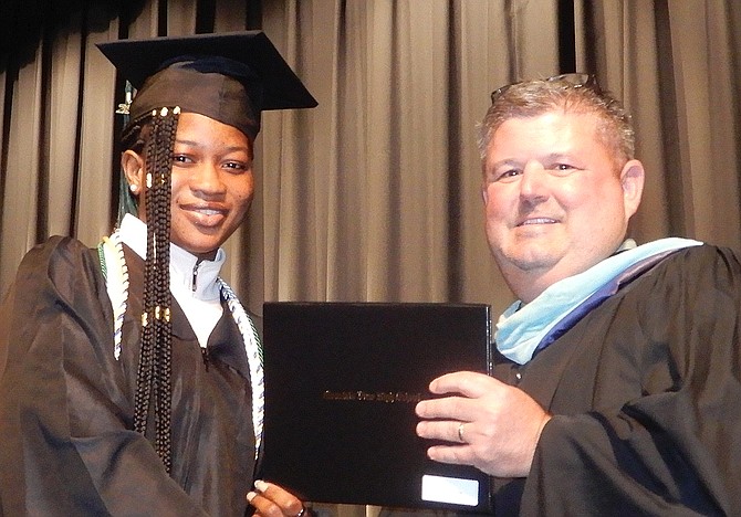 Sandra Ofori receives her diploma from Joe Thompson.