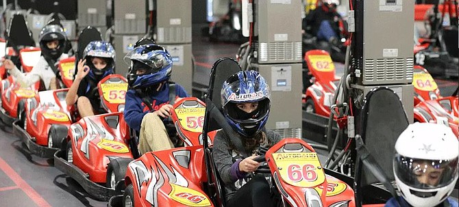 Racers at the Autobahn Indoor Speedway near Dulles rev their engines.