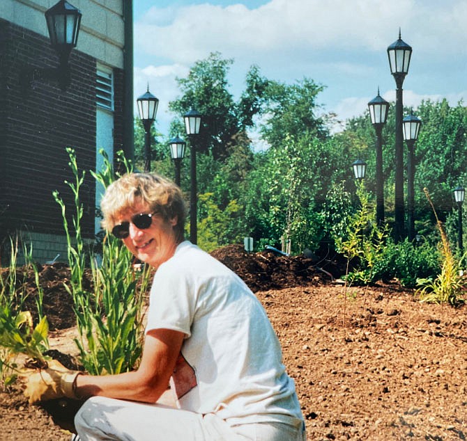 Robin Rentsch helps to plant the Great Falls Library native garden.