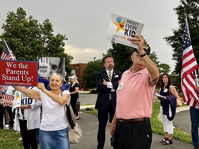 Center back, Sebastian Gorka, former deputy assistant to President Donald Trump (2017), watches protestors hold signs from Stand Up Virginia and The Family Foundation. “The transgender movement in America today is evil,” Gorka said.