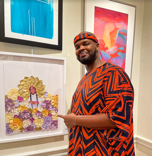Rashad Ali Muhammad talks about his work “Abundance,” a mixed media work on specialty paper using ink, glitter and faux petals at a reception for newly juried Torpedo Factory artists Aug. 5 at the Principle Gallery on King Street.
