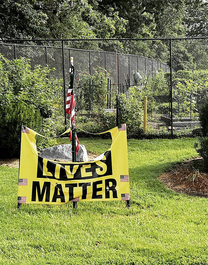 The Black Lives Matter banner appears slashed at the Unitarian Universalist Church of Reston.