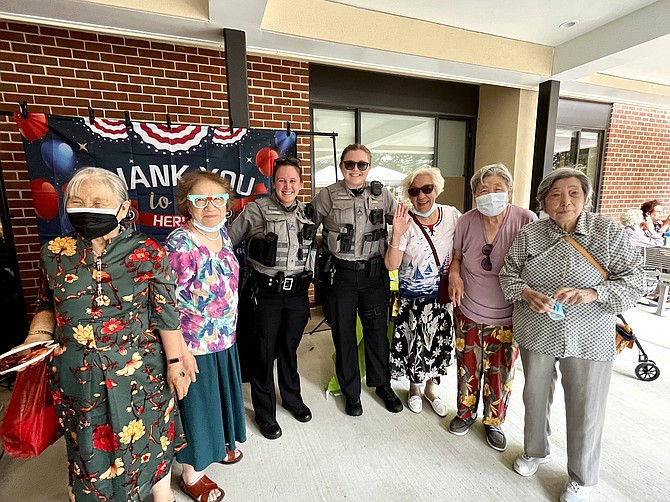 Residents of Hunters Woods with two of their police "HEROES," C.J. Hughs and A.K. MacLaughlin, (center left to right).