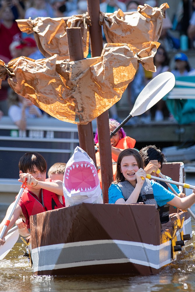 The finish line is in sight for these competitors in the 2022 Lake Anne Cardboard Boat Regatta in Reston, a project of the Reston Historic Trust.