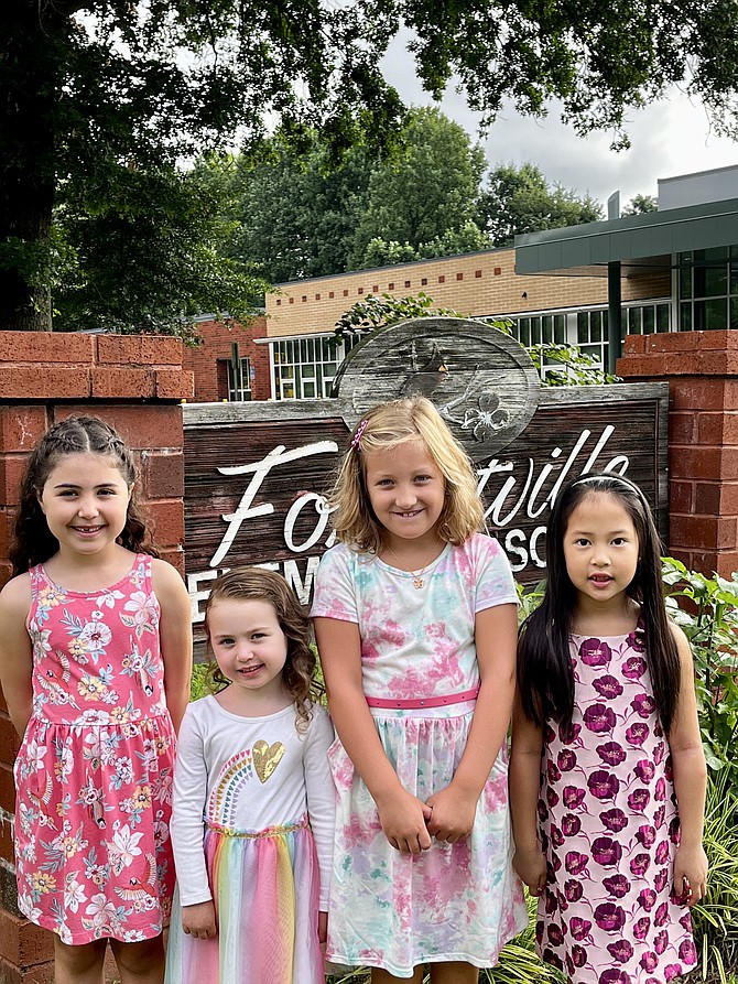 On the first day of school for Fairfax County Public Schools students, four friends (from left), Emma, 6, Ava, 3, Reese, 7, and Alyse, 6, all of Great Falls meet at the sign in front of Forestville Elementary.