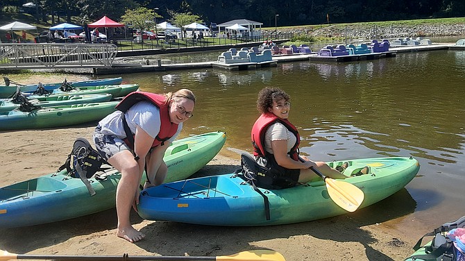 West Springfield residents Alania Archie, left, and Lindsay Innis launch kayaks in the boating area.
