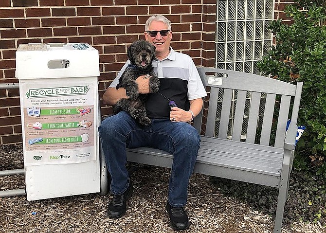 Michael Forrester and dog Maxx enjoying the Trex bench in Chantilly Highlands.