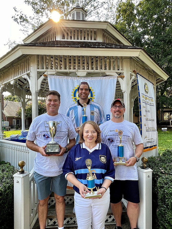 Bottom row, Jackie Plunkett, (top row from left), Michael Broyles, president of the Rotary Club of Great Falls, Brian Plunkett, and Steve Flannery, Rotarian and event organizer, hold the trophies that will be awarded to the winning bocce ball teams.