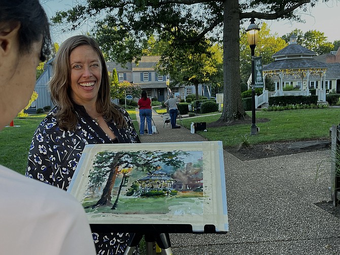Plein air painter Vicky Zhou adds the final brush strokes to her watercolor just before sunset, the Golden Hour, when objects glow and shadows are more interesting. Zhou of Oakton later won 2nd Place & People’s Choice for her painting, “Shady Spot.”