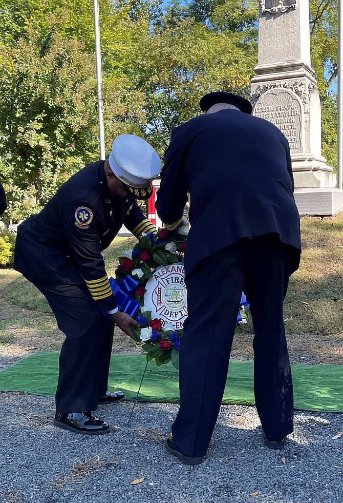 Alexandria Fire and EMS Chief Corey Smedley, left, and Volunteer Fire Department President Jay Johnson place a wreath at the Memorial to Fallen Firefighters Oct. 14 at Ivy Hill Cemetery as part of National Fire Prevention Week ceremonies.