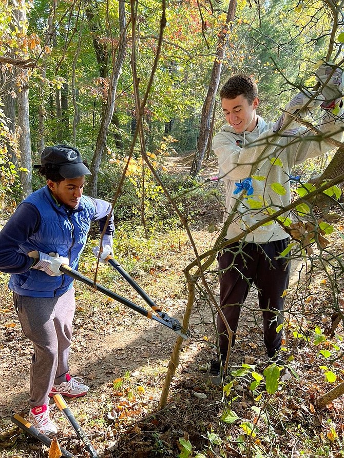 Members of the Laurel Hill Park volunteer team, Lael Dessalegn and Michael Oswald, attack ‘Dragons’ armed with garden pruners and leather gloves.