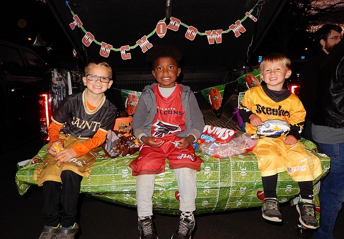 Brothers (from left) Benjamin, Isaac and James Seibert with lots of candy.