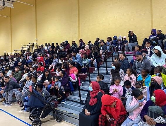 Hundreds of families crowd the gym at Charles Houston Recreation Center Oct. 11 for the Firefighters and Friends annual coat distribution.