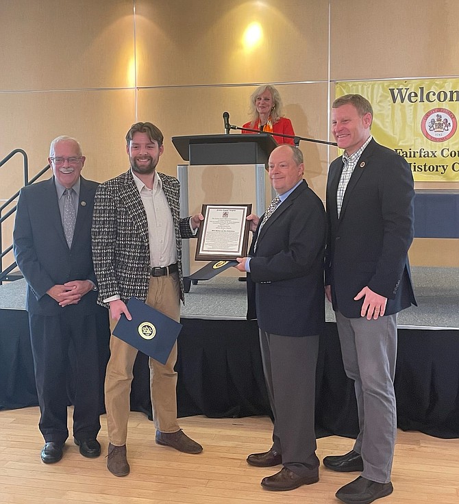 Plaque presented to Mike Salmon and Ean Eschenburg by Rep. Gerry Connolly, left, and Chairman Jeff McKay.