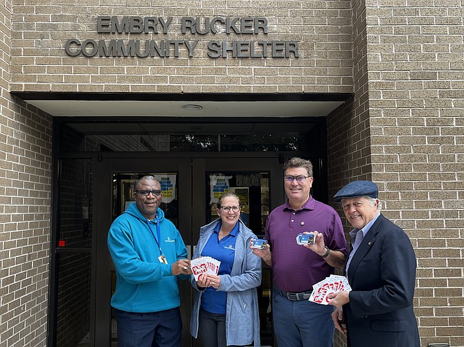 From left, Everett George at Cornerstones and Meridith Hovan, vice president of resource development at Cornerstones, accept $1,000 of Target and Mobile gas gift cards from Michael Broyles, president of the Rotary Club of Great Falls, and Bob Dinkel, Rotary's Cornerstones point person outside of the Embry Rucker Shelter in Reston.