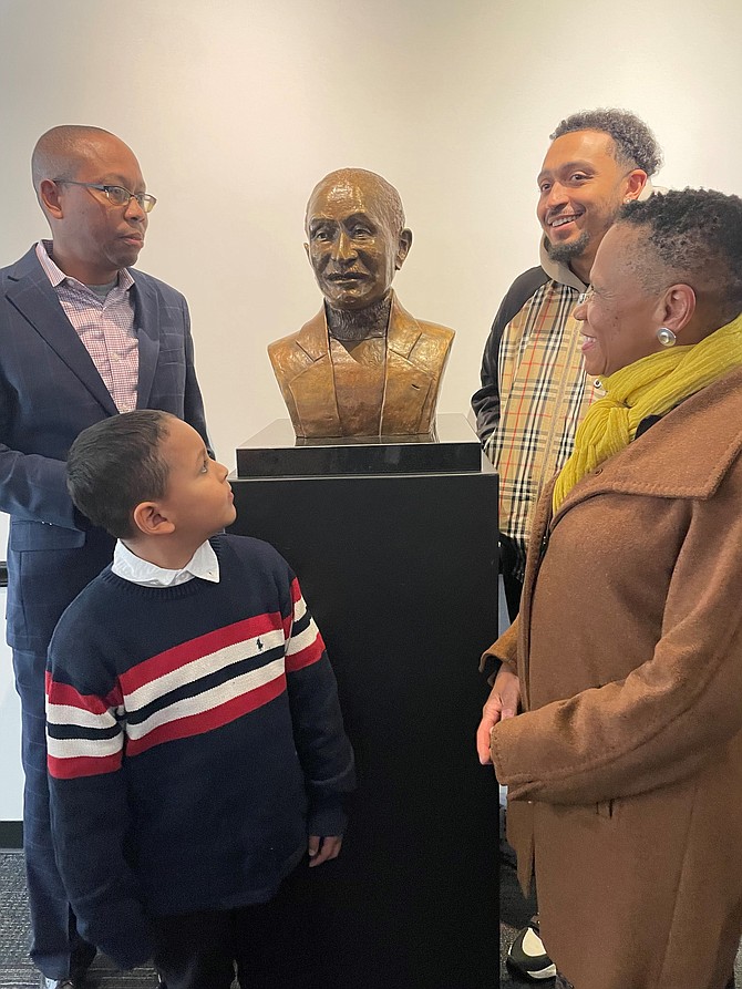 The family of the late A. Melvin Miller - son Marc Miller, great grandson Jeremiah Miller, grandson Max Miller, and daughter Ericka Miller - stand by the bust of the former ARHA board chair following the Nov. 17 renaming of the ARHA headquarters building in Miller’s honor.