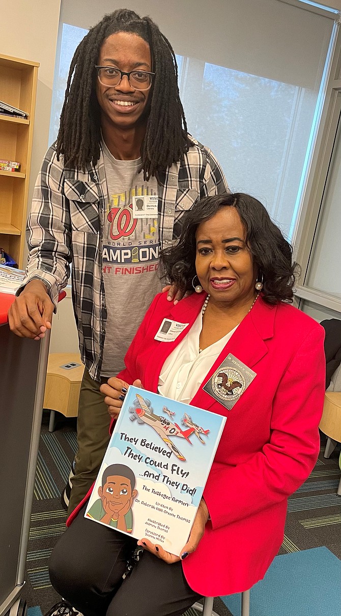 Author Deborah Hall-Greene Thomas, right, with son Derrick, following a presentation on the Tuskegee Airmen Nov. 15 at Ferdinand T. Day Elementary School.