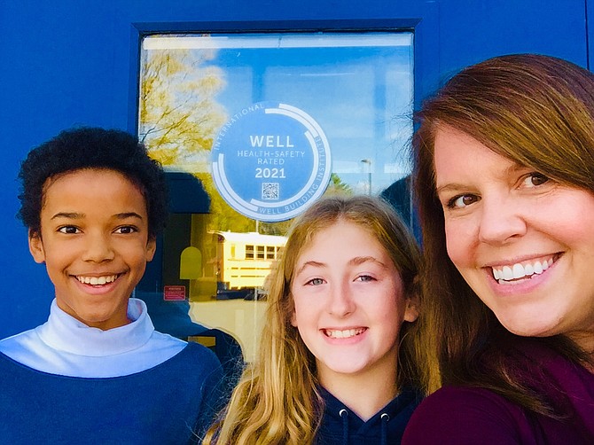Principal Sara Harper displays energy awards with Halia Ochieng and Alexa Landi, who are 6th graders at Great Falls Elementary School and the co-founders of Climate Conservation Club (CCC).