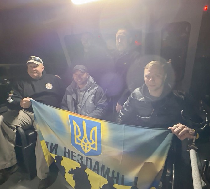 Capt. Ed Moore poses with his passengers for the day, (seated) Ruslan Tyshchenko, Alex Fedun, (standing) the Veteran’s Success Resource Group representative, and Anatoliy Kirda.