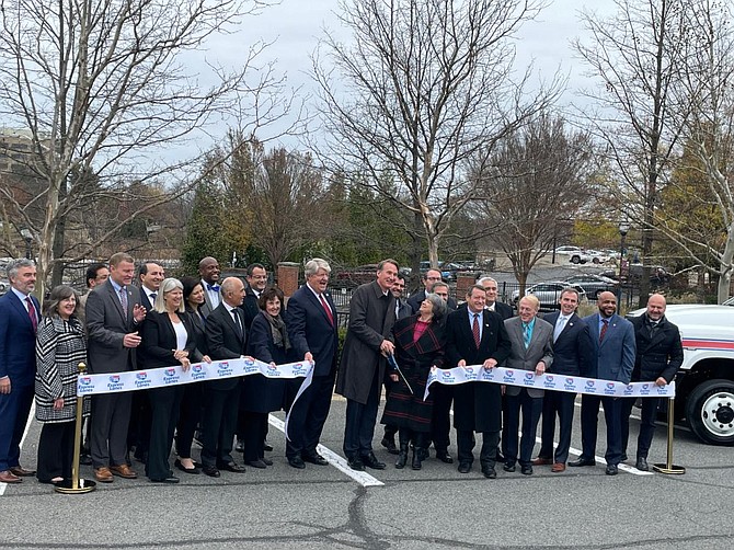 With scissors in hand, Gov. Glenn Youngkin (R-VA) cuts the ribbon for the I-66 express lanes. Youngkin was not on hand for the opening of the Silver Line Extension earlier in November.