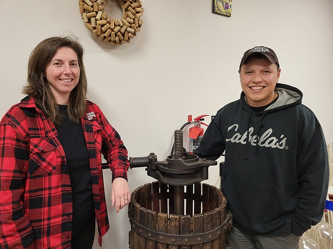 Bonnie and Andrew Rosado with a family grape press from the 1920s.