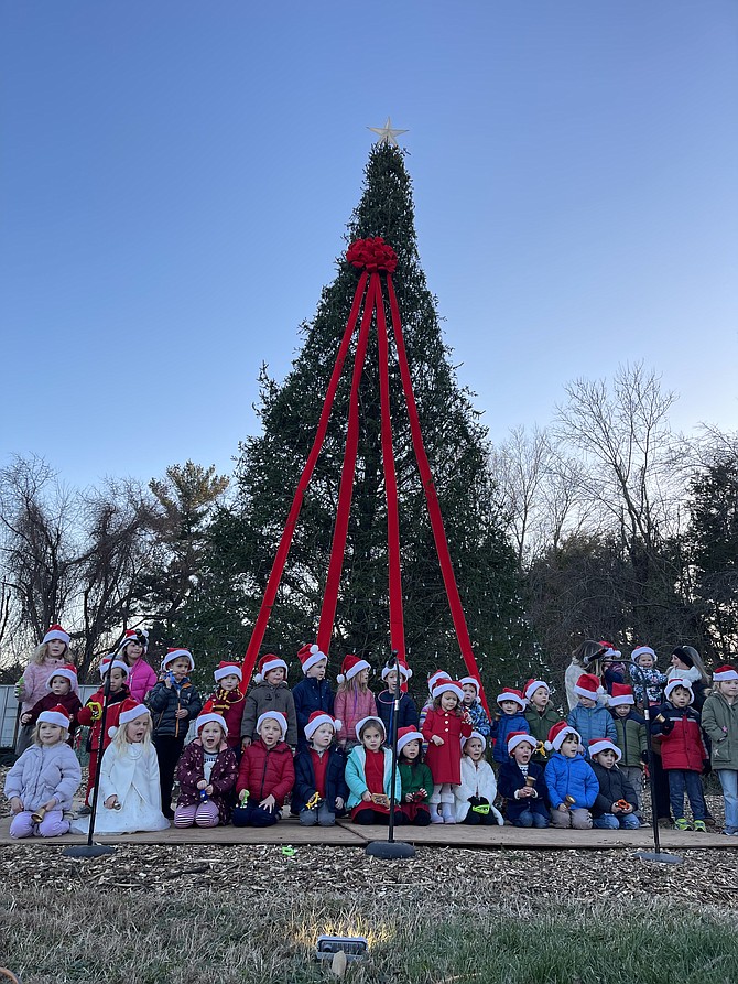 Children from Great Falls United Methodist Preschool wearing Santa hats sing in front of the Christmas tree on Sunday, Dec. 4, at the Celebration of Lights organized by Celebrate Great Falls Foundation.