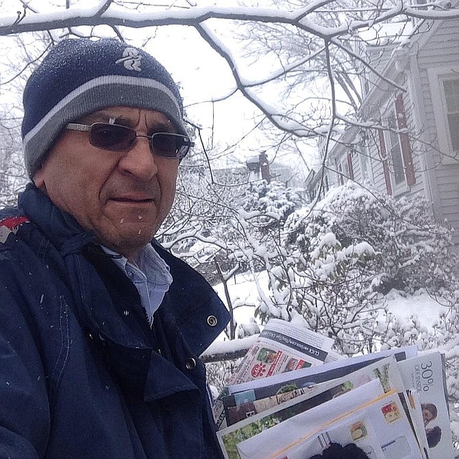 Jesus Collazos delivering the mail in a snowstorm.